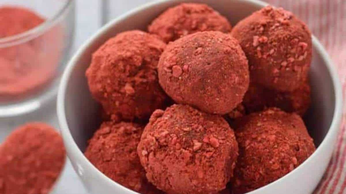 A bowl full of red balls in a white bowl, ready to be shared.