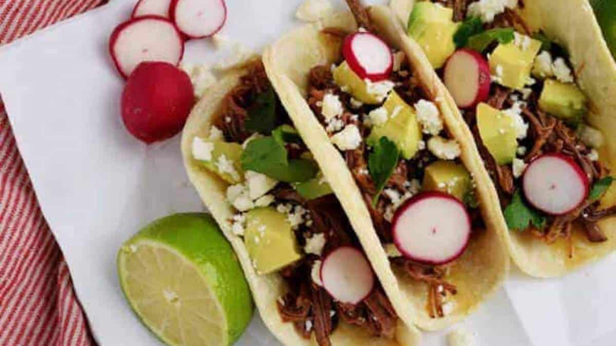 Shared comfort food recipes for pulled pork tacos with radishes and limes.