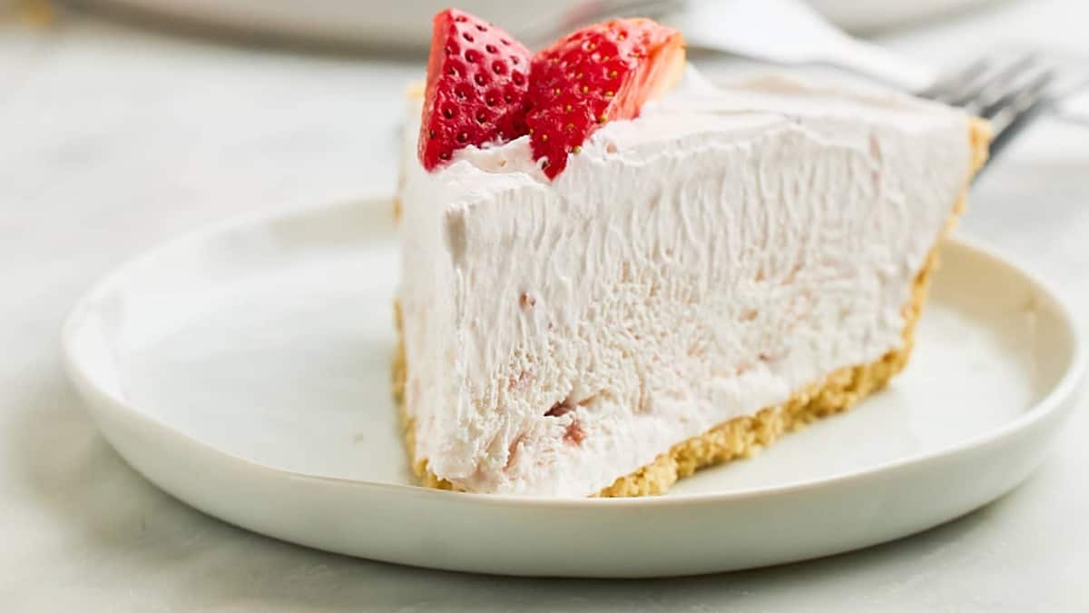 A slice of strawberry yogurt pie on a white plate.