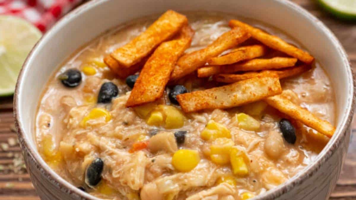 Chicken tortilla soup recipe in a bowl with tortilla chips.