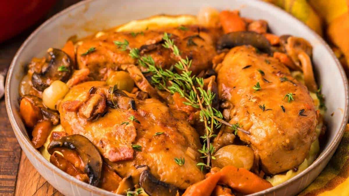 Chicken breasts and vegetables in a casserole dish.