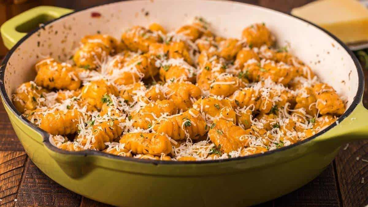 Cheesy gnocchi shared in a green pot.