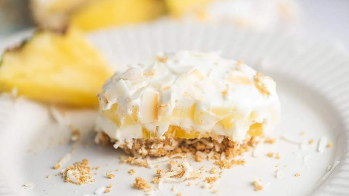 A slice of shared pineapple cake on a white plate.