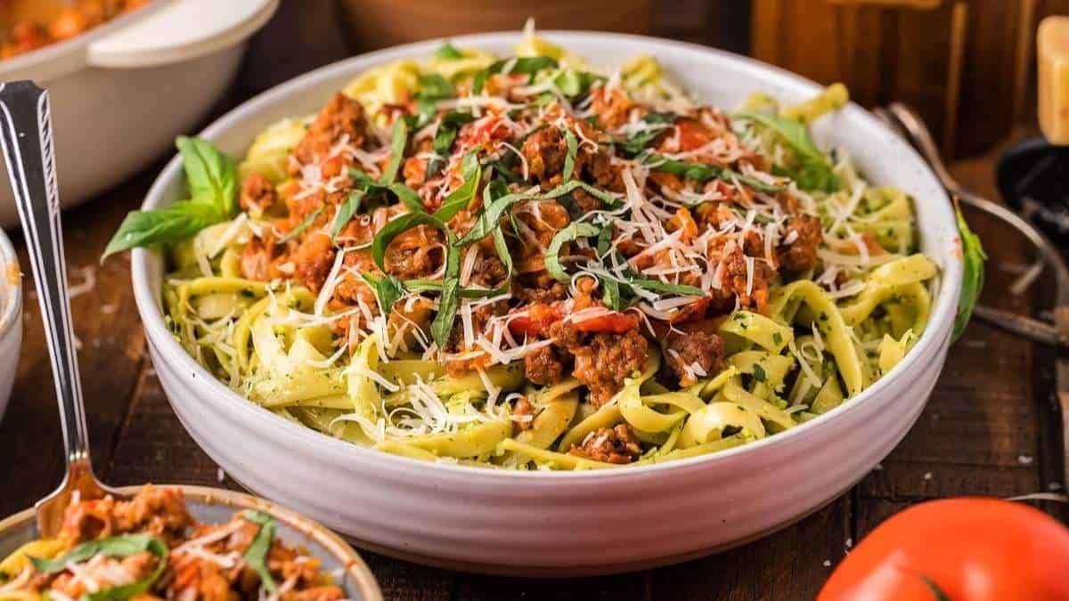 A comforting bowl of shared pasta with meat, tomatoes and basil.