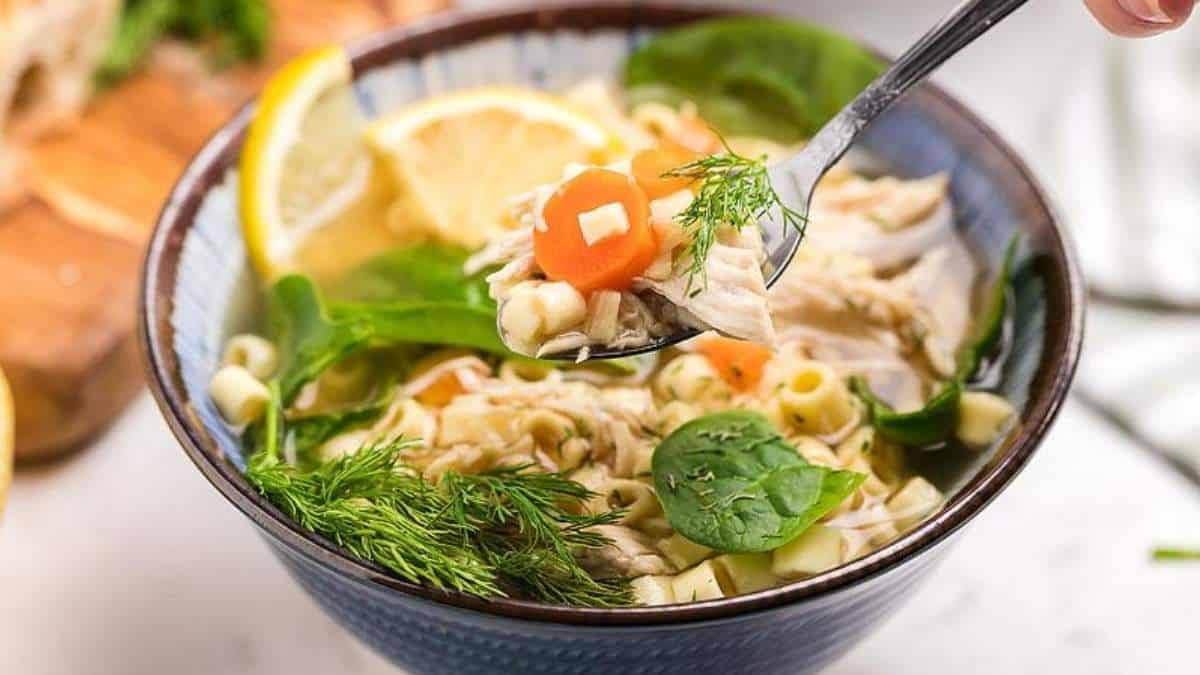 A delicious bowl of chicken noodle soup packed with fresh spinach and a hint of lemon.