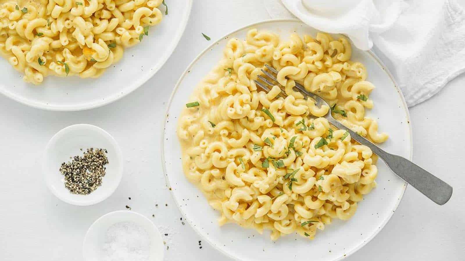 Two plates of macaroni and cheese on a white background.