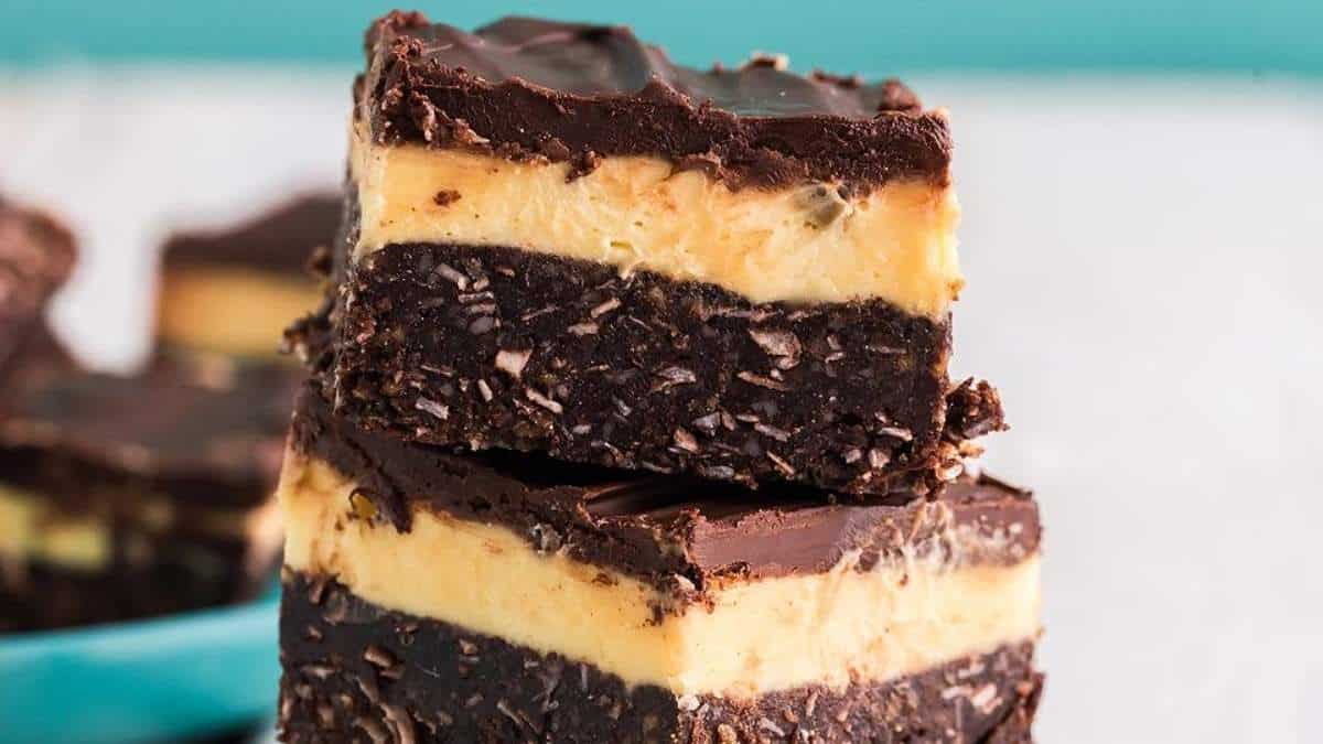 A stack of shared chocolate and peanut butter fudge, a delicious round up of no bake desserts.