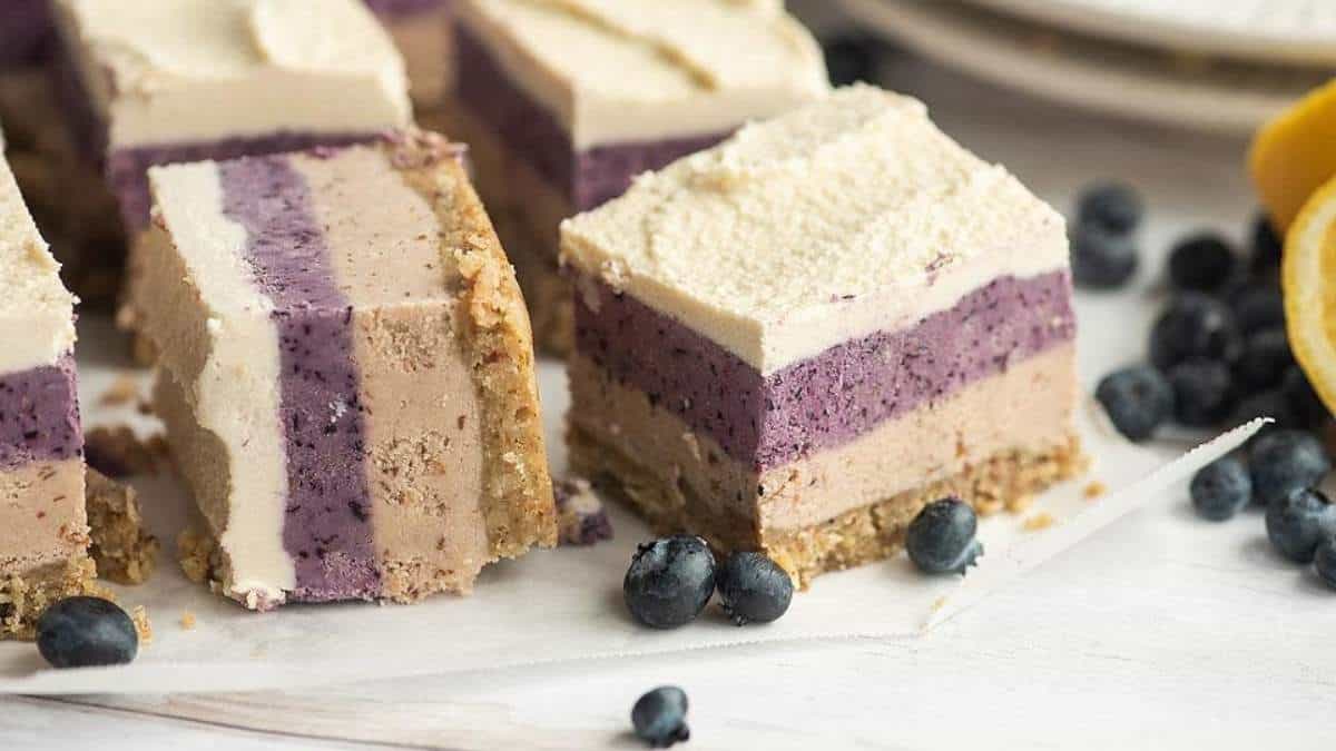 A slice of blueberry ice cream cake, a no bake dessert, on a plate.