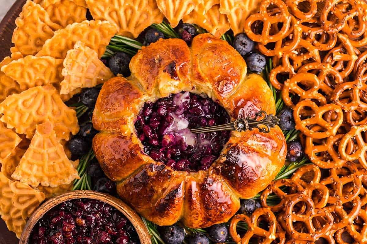 A platter with pretzels, blueberries and cranberry sauce.