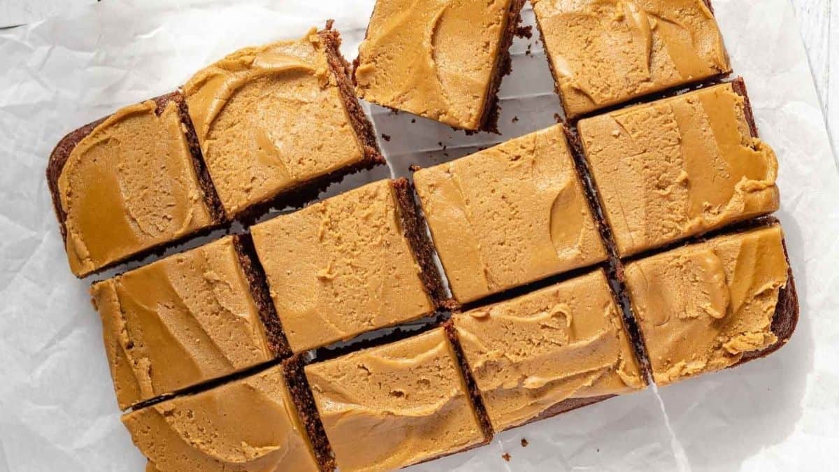 Peanut butter brownies cut into squares on a piece of paper.
