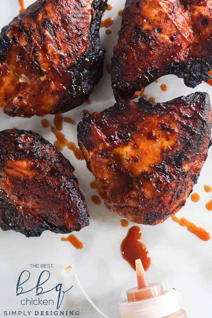 Bone-in BBQ ribs with sauce on a white plate.