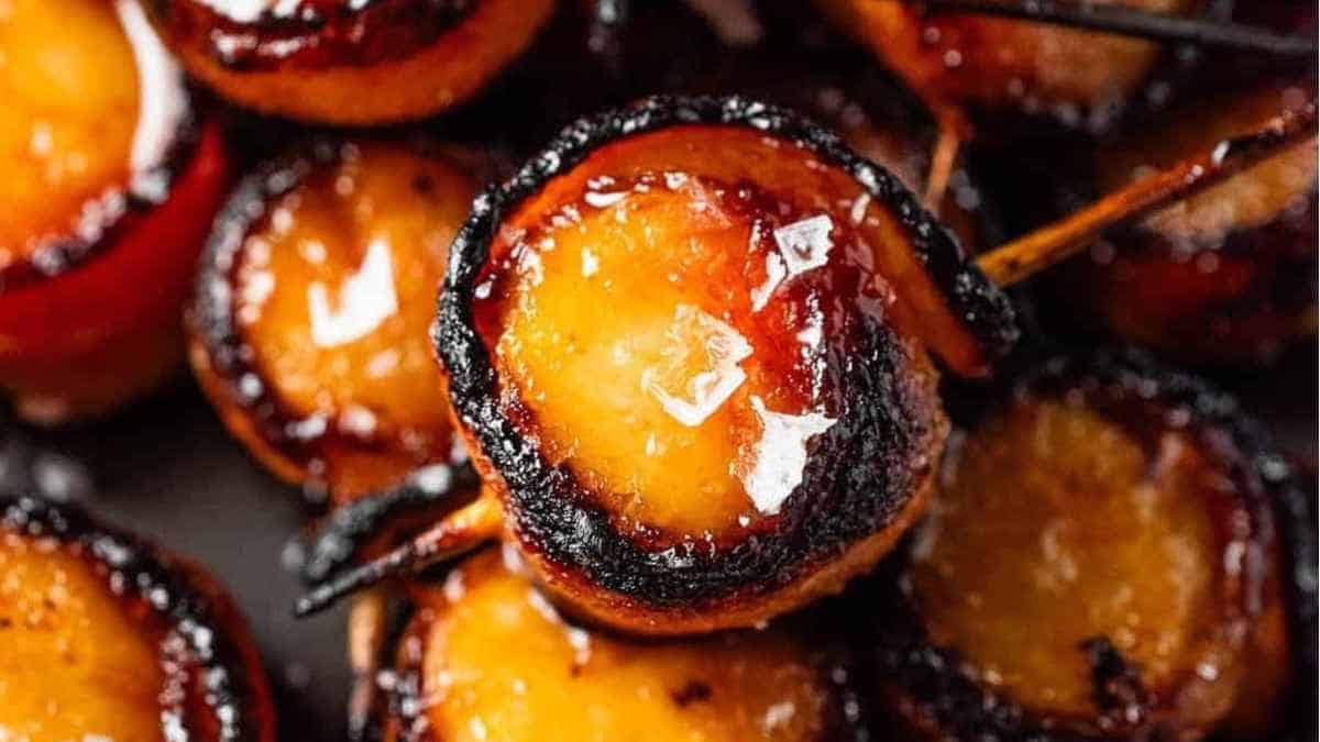 A close up of a skewer of roasted bananas.