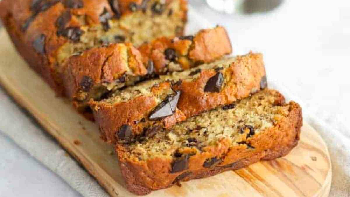 A slice of chocolate chip banana bread on a cutting board.