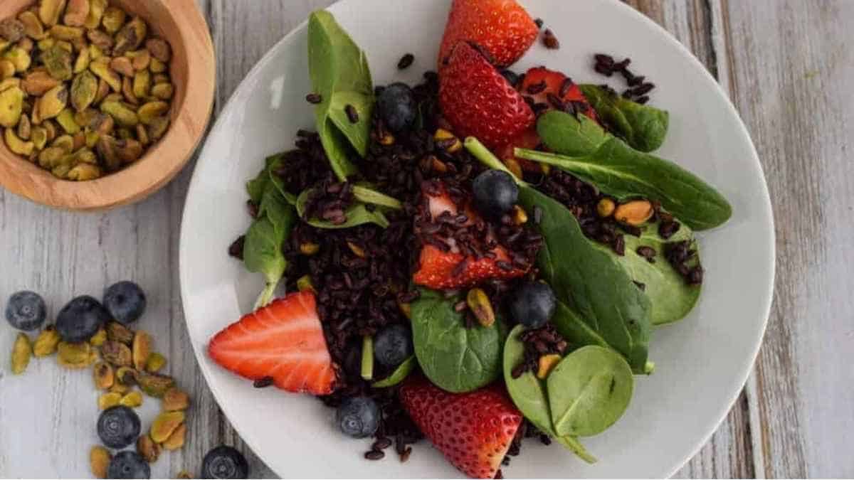 Black rice salad with strawberries and pistachios.