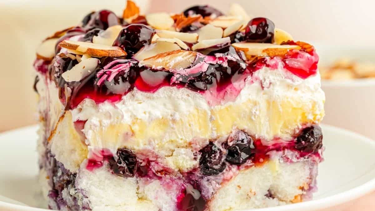 A slice of blueberry ice cream cake on a plate.
