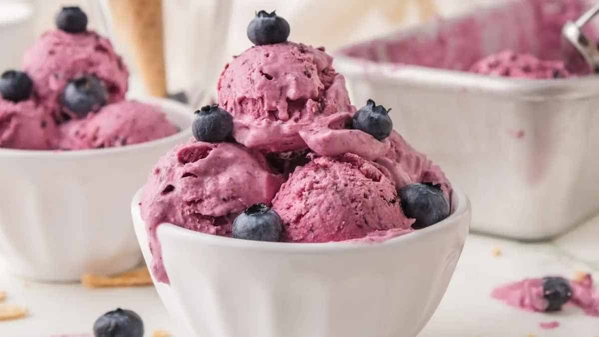 Blueberry ice cream in white bowls.