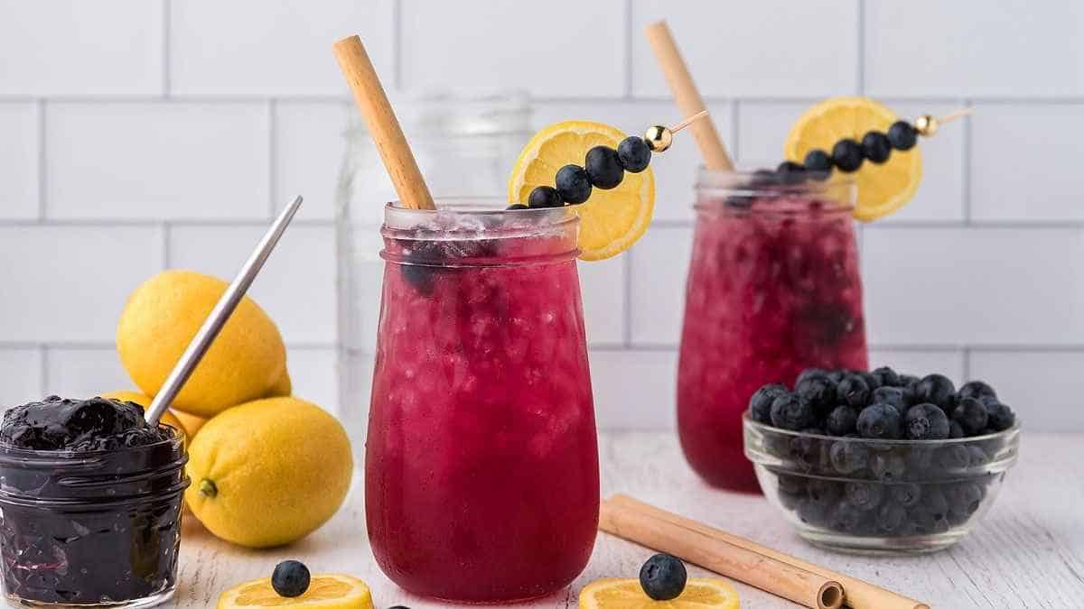 Blueberry lemonade with lemon wedges and lemon slices.