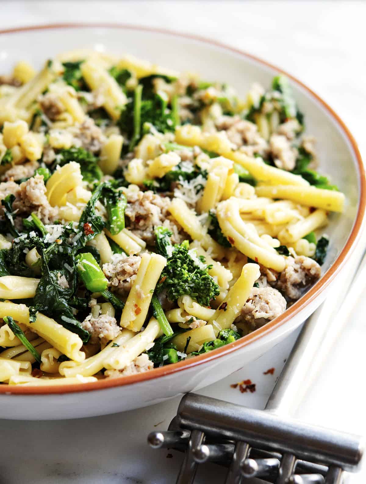         A delicious bowl of pasta with sausage and swiss chard, perfect for sausage recipe enthusiasts.