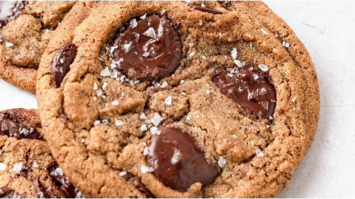 A close up of a chocolate chip cookie with sea salt.