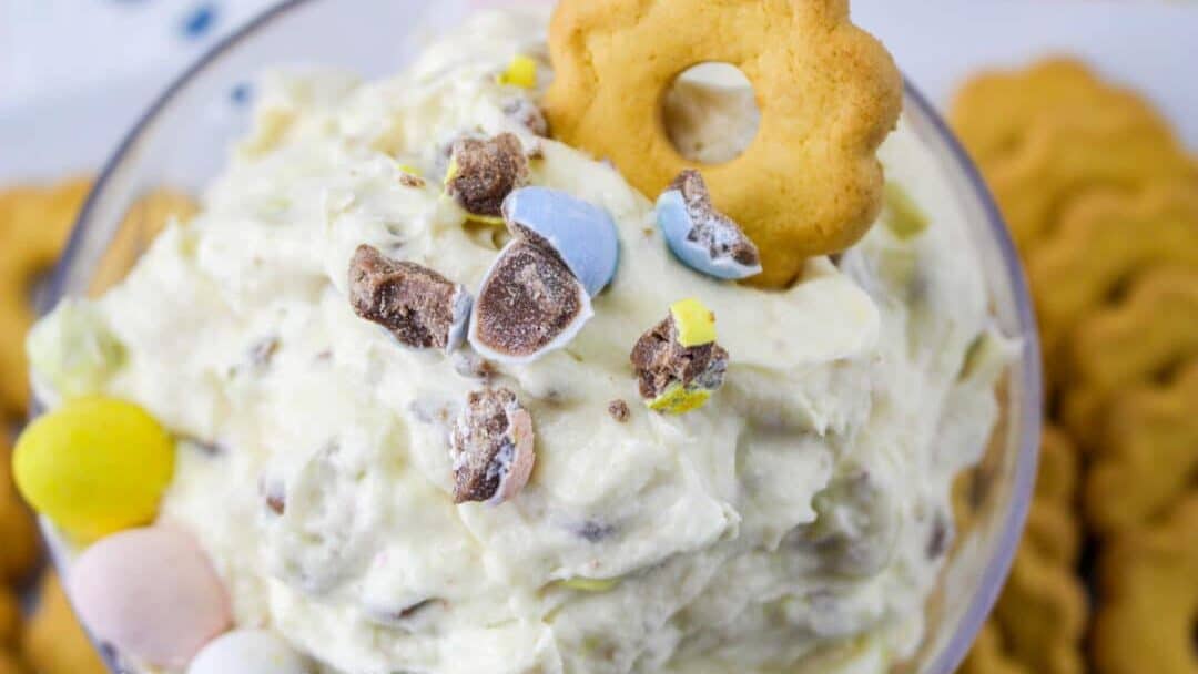 Easter dip in a bowl with cookies and eggs.