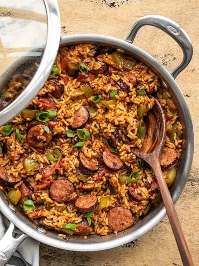 Sausage and rice in a skillet with a wooden spoon - A flavorful combination of sausage and rice cooked to perfection using just a wooden spoon. Discover the best sausage recipes here!