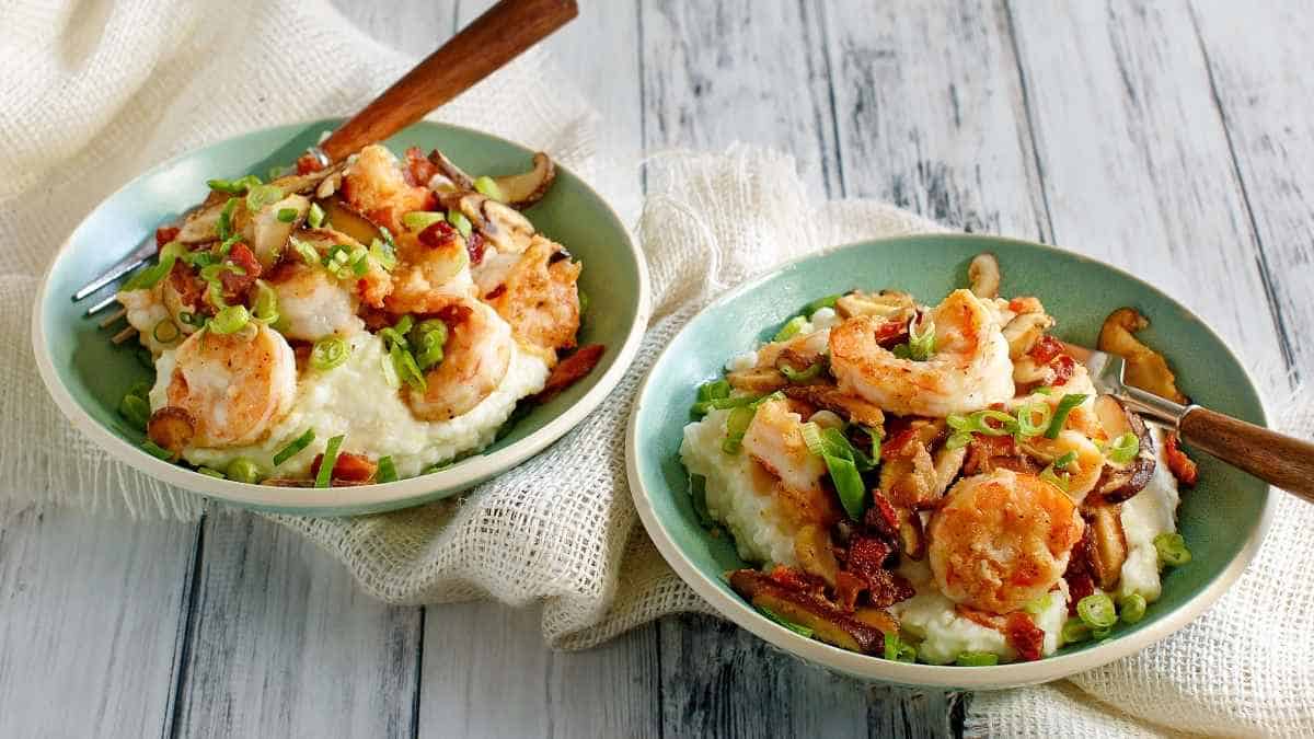 Two bowls with shrimp and mashed potatoes.