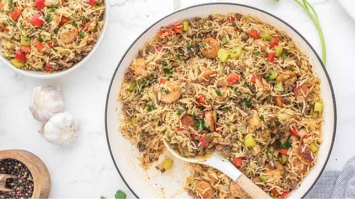 Fried rice with shrimp and vegetables in a white bowl.