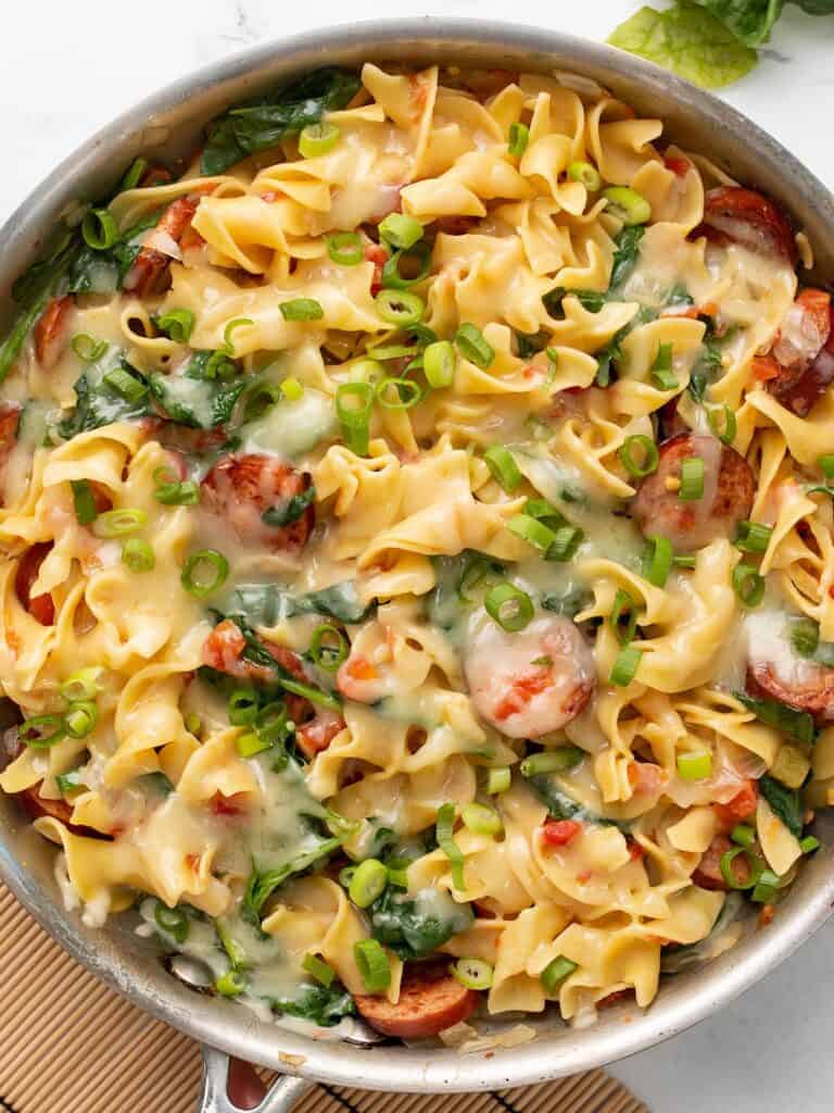 A delicious skillet full of pasta with sausage and spinach, perfect for those looking for easy sausage recipes.