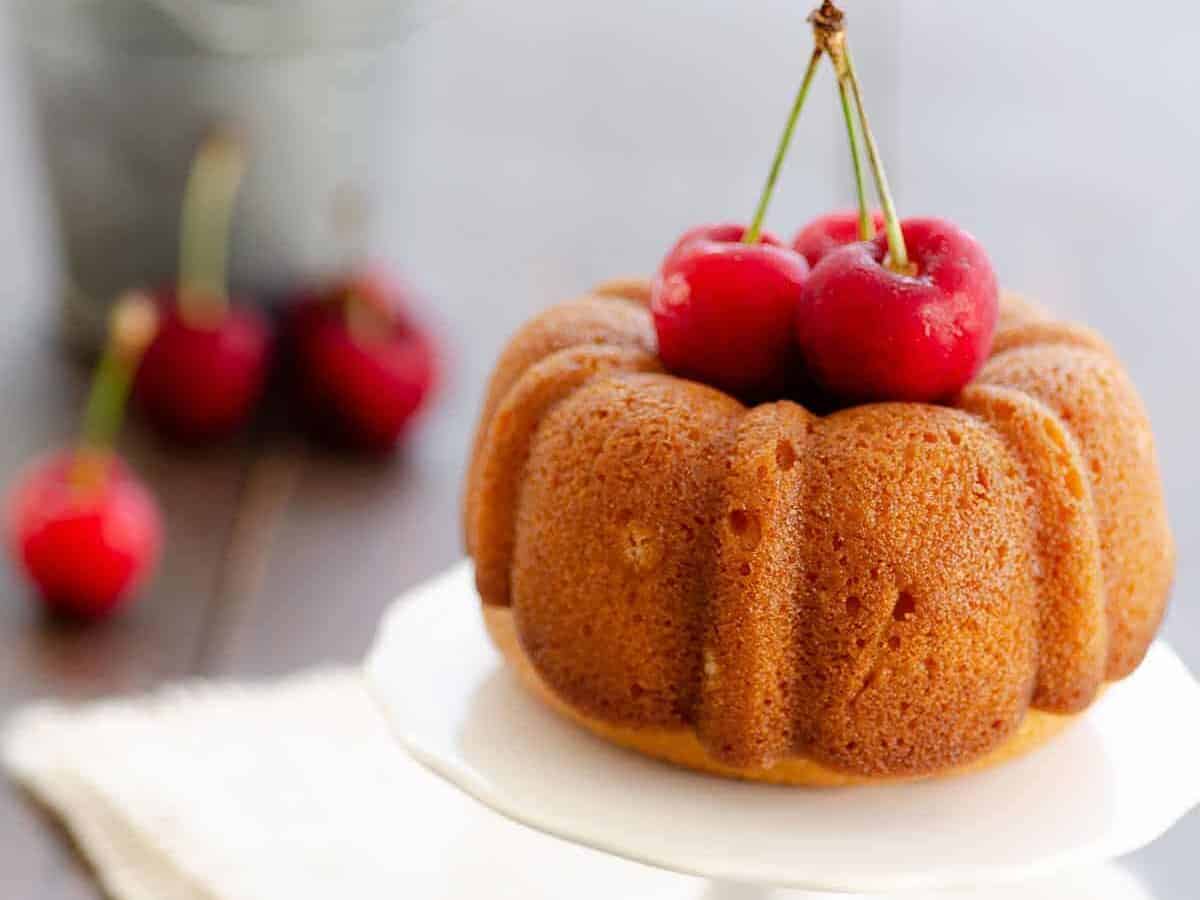 A bundt cake with cherries on top.