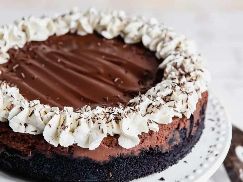 A chocolate cheesecake on a white plate.