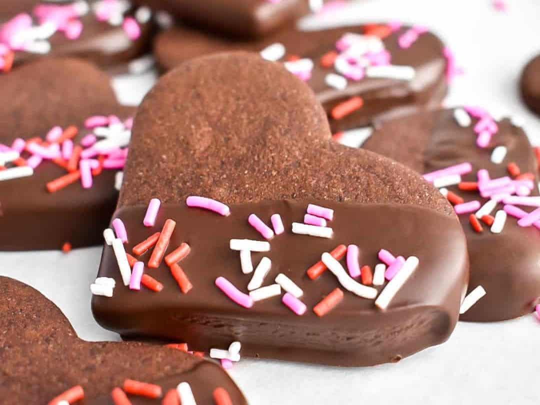 Chocolate heart shaped cookies with sprinkles.