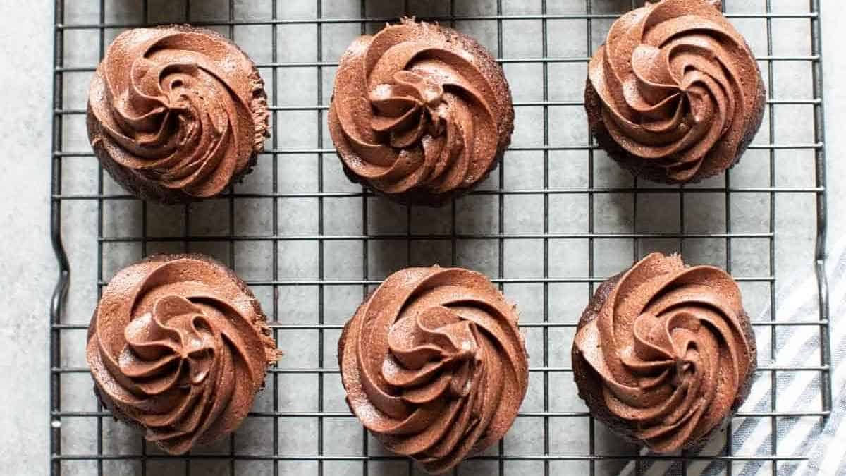 Chocolate cupcakes on a cooling rack.