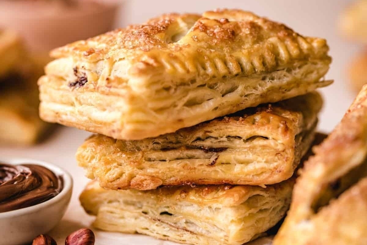 A stack of pastries with chocolate and nuts.