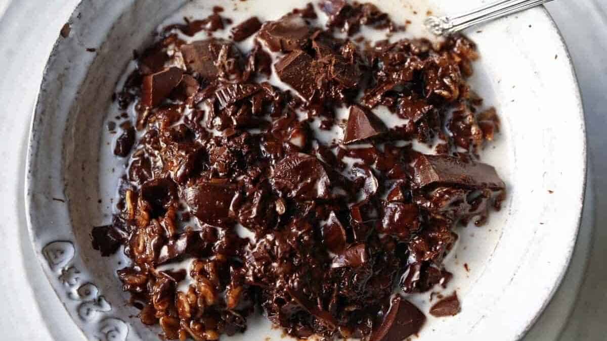 A dish with chocolate and pecans in it.