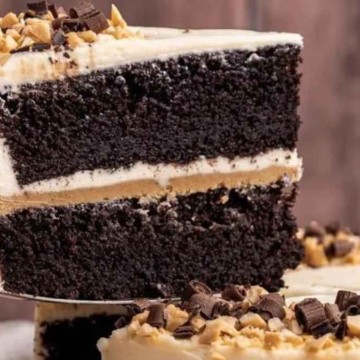 A slice of chocolate cake with peanut butter frosting.