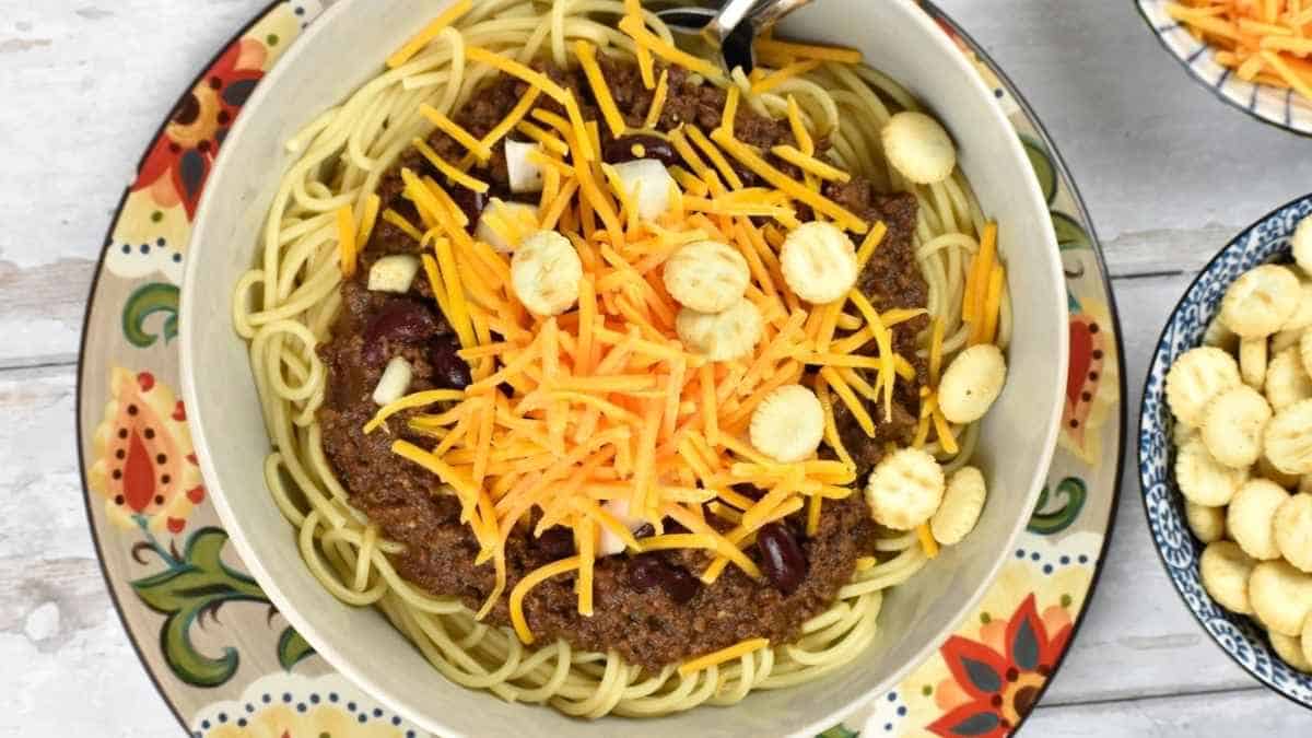 Chili in a bowl with cheese and crackers.