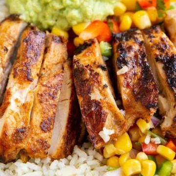 Grilled chicken with rice and guacamole in a bowl.