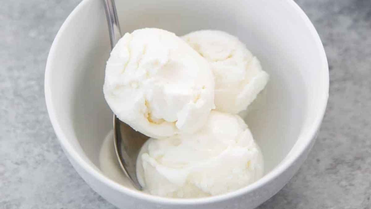 Three scoops of ice cream in a white bowl.