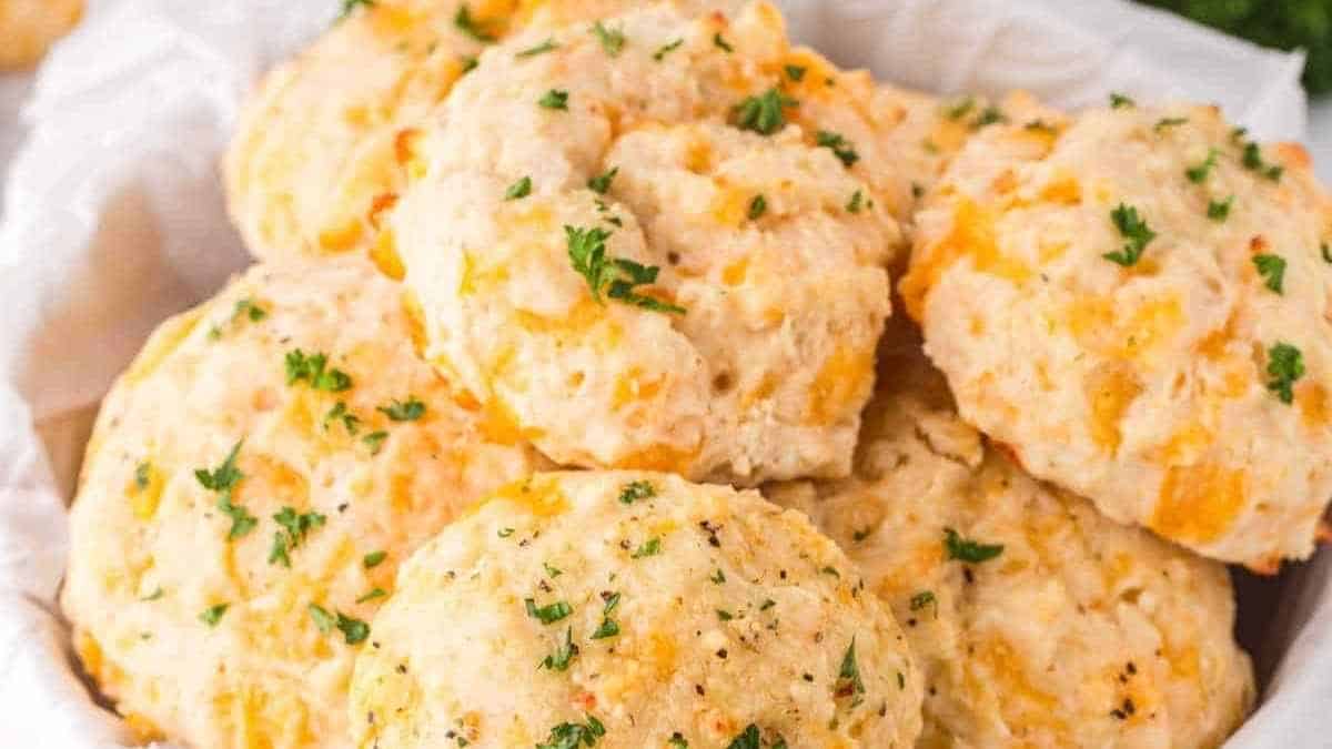 Cheesy biscuits in a white bowl with parsley.