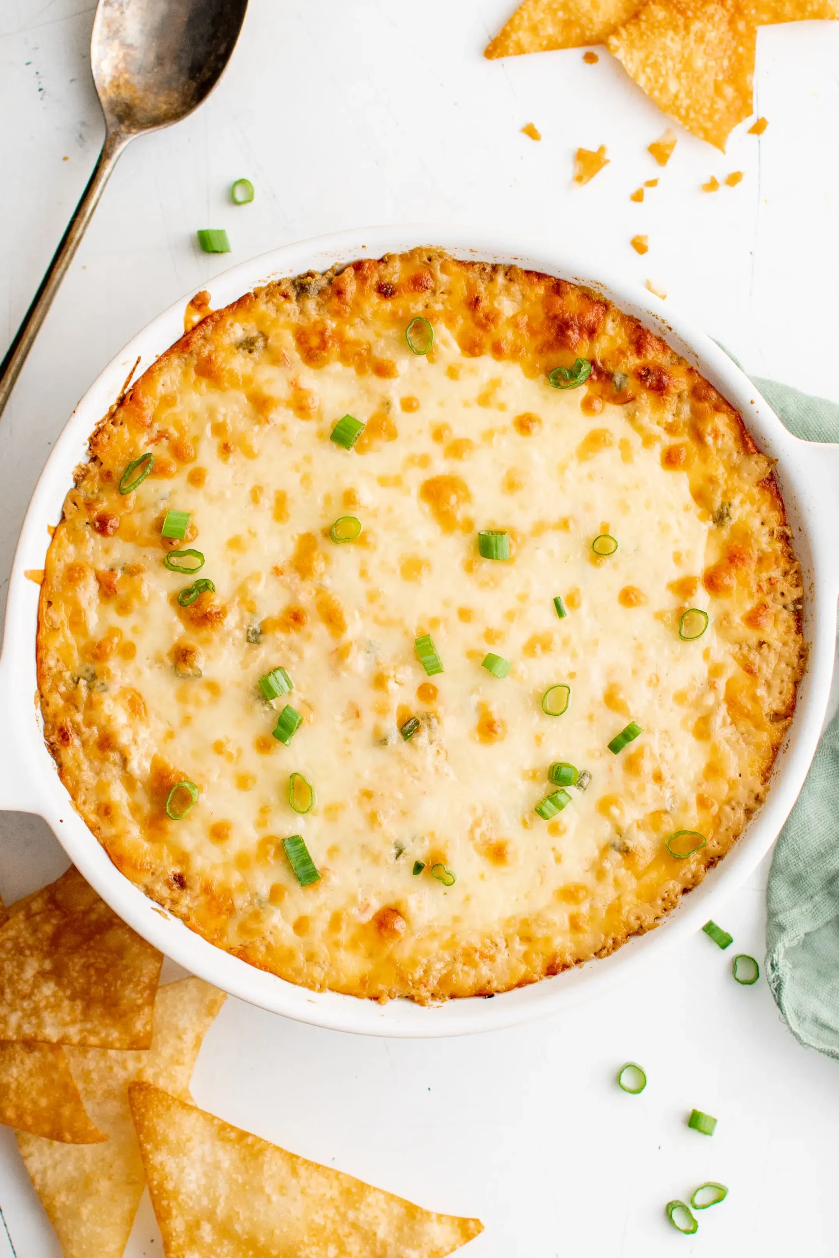 Cheesy dip in a white dish with tortilla chips, perfect for imitation crab recipes.