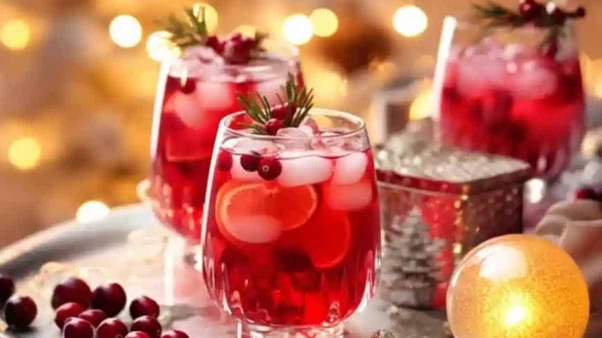 Three glasses of cranberry drink on a tray.
