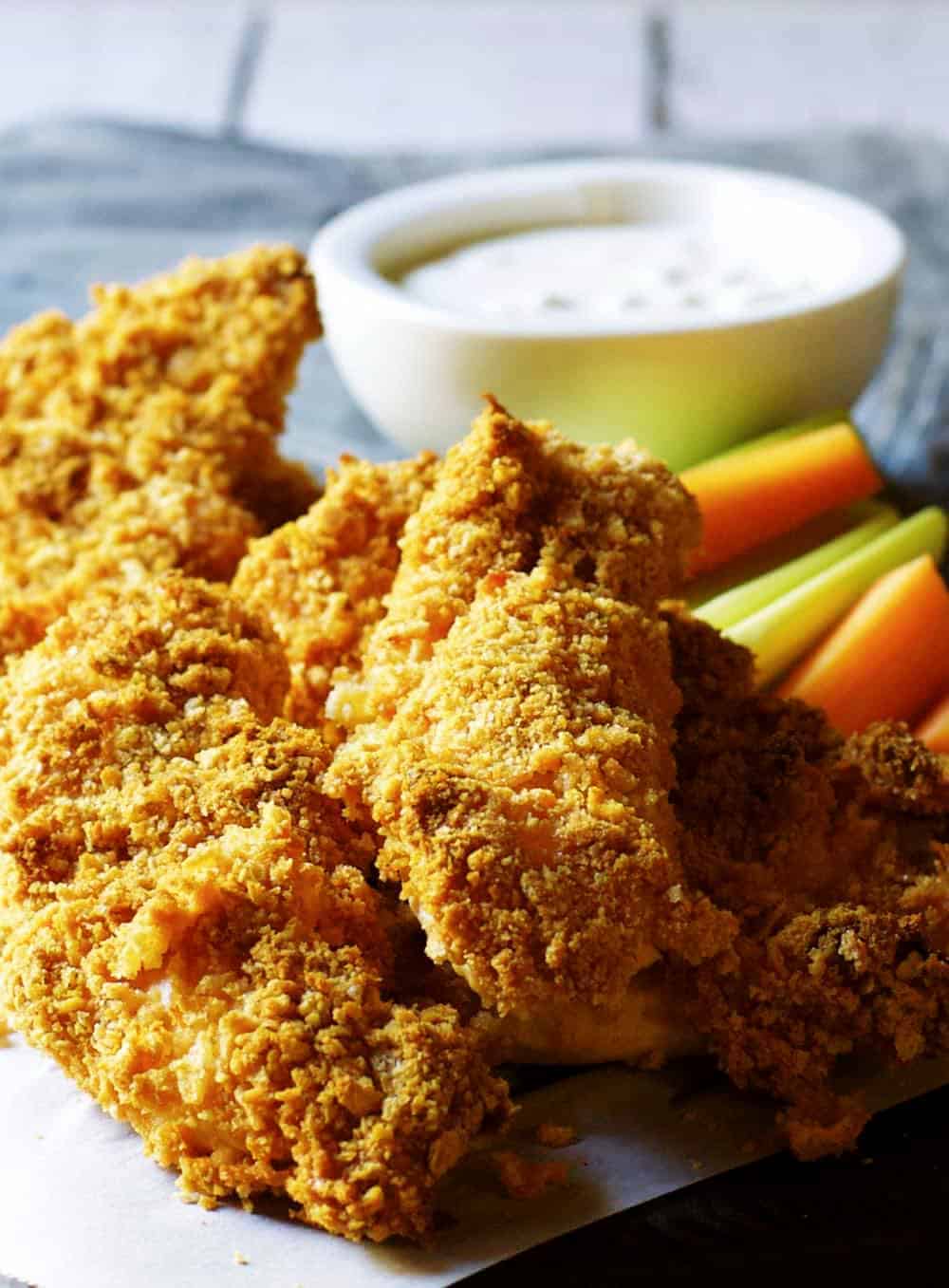 Delicious chicken tenders with a tantalizing dipping sauce, served on a plate.