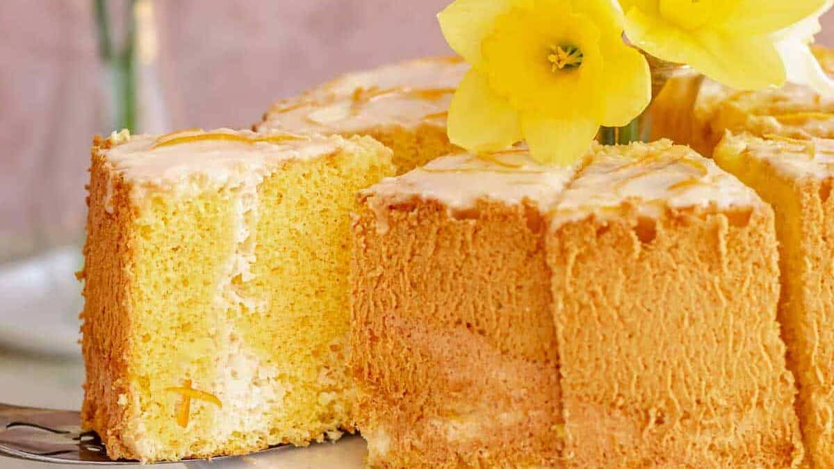 A yellow bundt cake with a slice taken out.