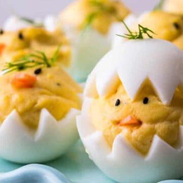 Easter deviled eggs on a blue plate.