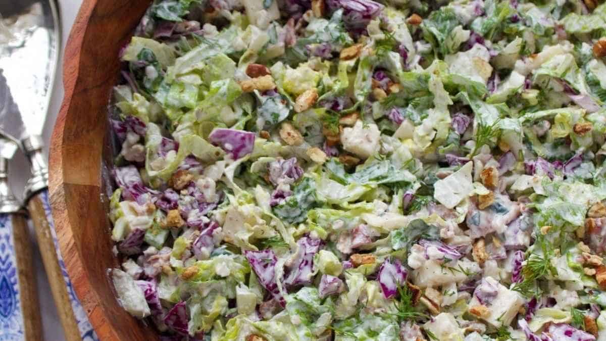 Cole slaw in a wooden bowl with a fork.