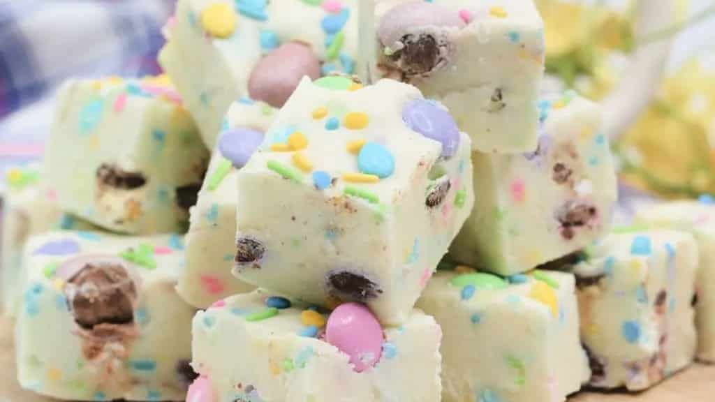 Easter fudge with sprinkles on a cutting board.