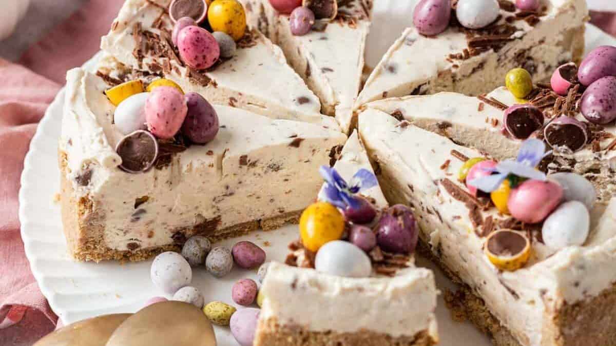A slice of cheesecake with easter eggs on a plate.