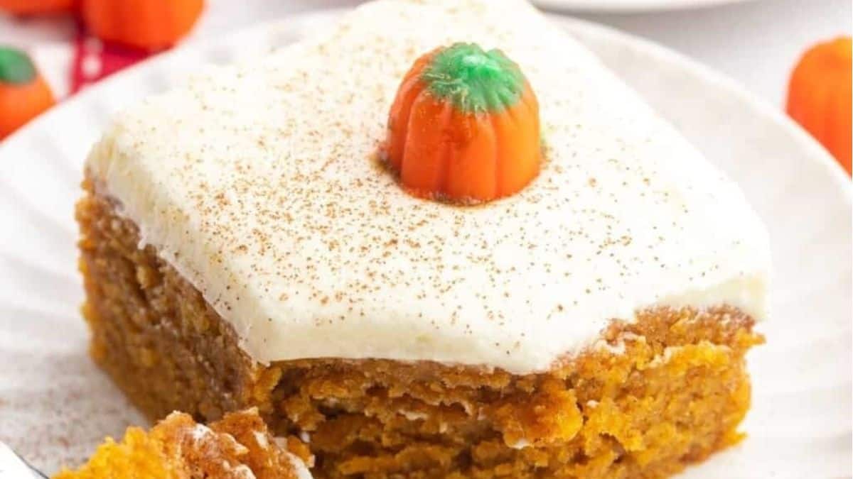 A slice of pumpkin cake on a white plate.