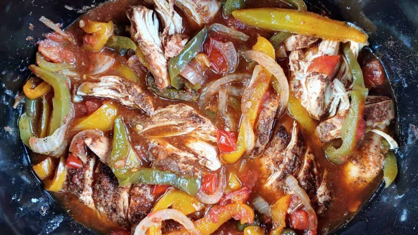 A bowl of food with meat and vegetables.