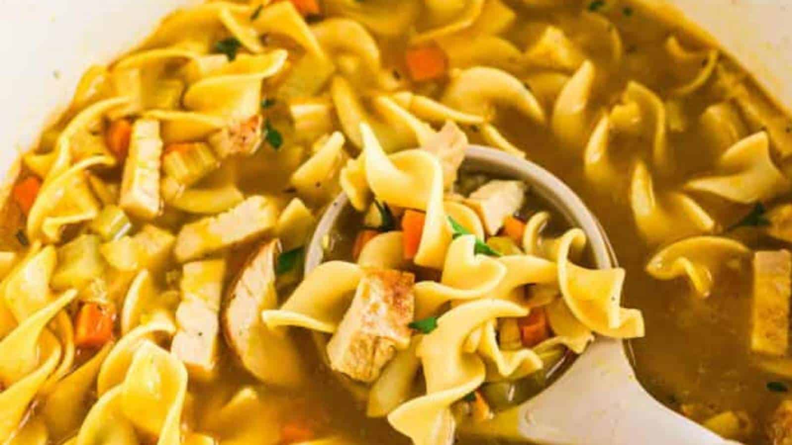 A bowl of soup with noodles and vegetables.